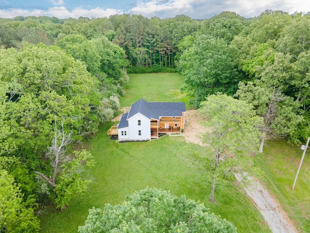aerial view of property and surrounding area featuring a forest