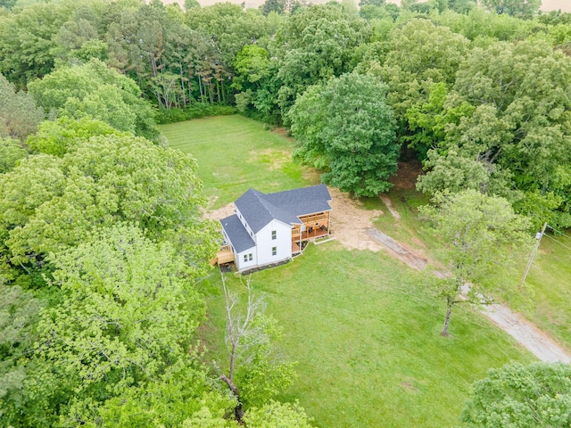 aerial view of property and surrounding area with a forest