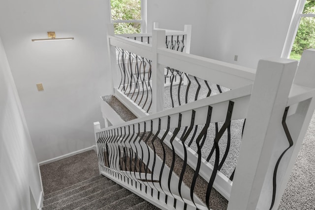 stairway with carpet floors and baseboards