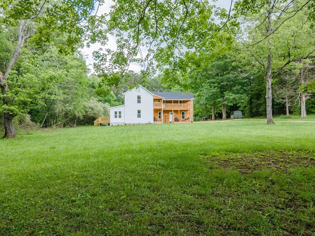 view of grassy yard with a wooden deck
