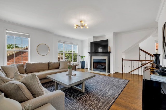 1206 Forest Lake Ct, Franklin, TN 37064 - living room featuring a chandelier, wood finished floors, stairway, crown molding, and a fireplace with flush hearth
