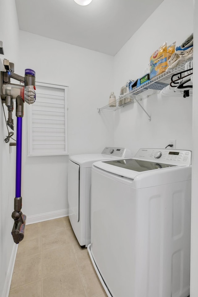 1206 Forest Lake Ct, Franklin, TN 37064 - clothes washing area with washer and dryer, light tile patterned floors, and baseboards