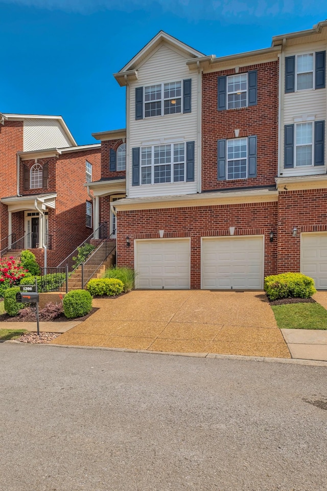 1206 Forest Lake Ct, Franklin, TN 37064 - view of property featuring concrete driveway, a garage, and brick siding