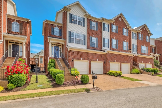 1206 Forest Lake Ct, Franklin, TN 37064 - view of property featuring concrete driveway, brick siding, a garage, stairs, and a residential view