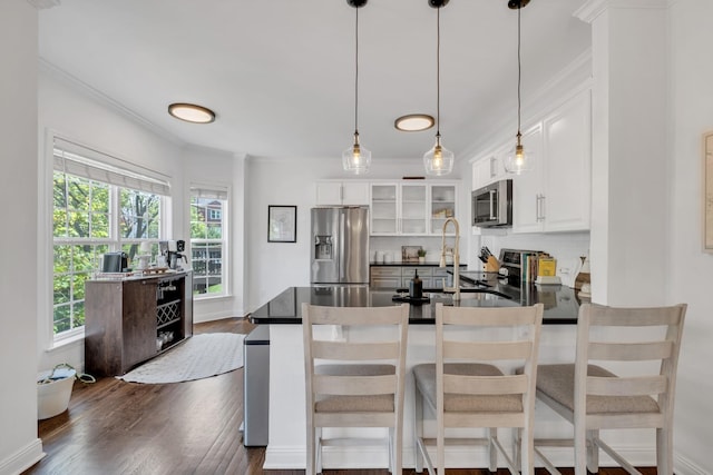 1206 Forest Lake Ct, Franklin, TN 37064 - kitchen with stainless steel appliances, dark countertops, ornamental molding, and plenty of natural light