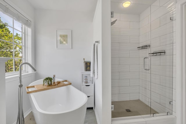 1206 Forest Lake Ct, Franklin, TN 37064 - bathroom featuring a stall shower, plenty of natural light, a freestanding tub, and baseboards