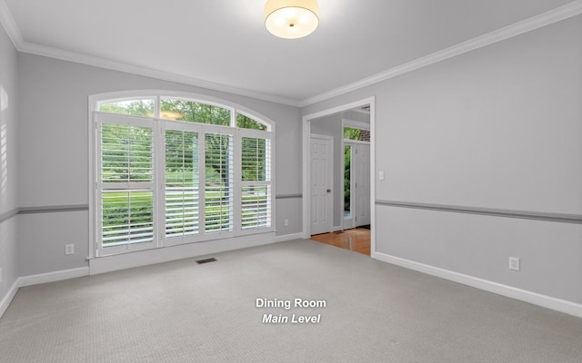 unfurnished room with carpet flooring, ornamental molding, and baseboards