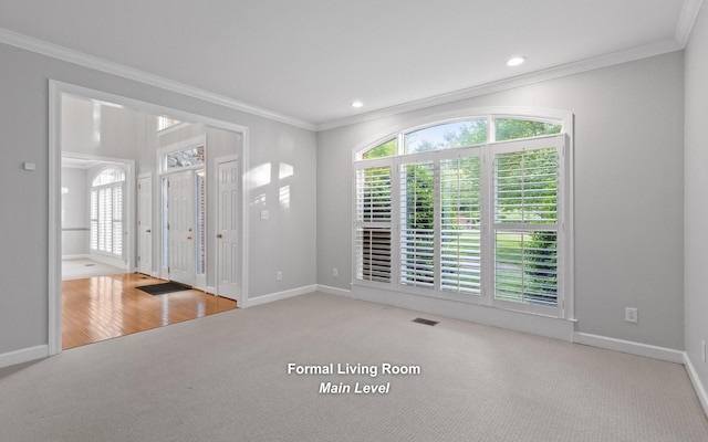 carpeted spare room with baseboards, ornamental molding, and recessed lighting