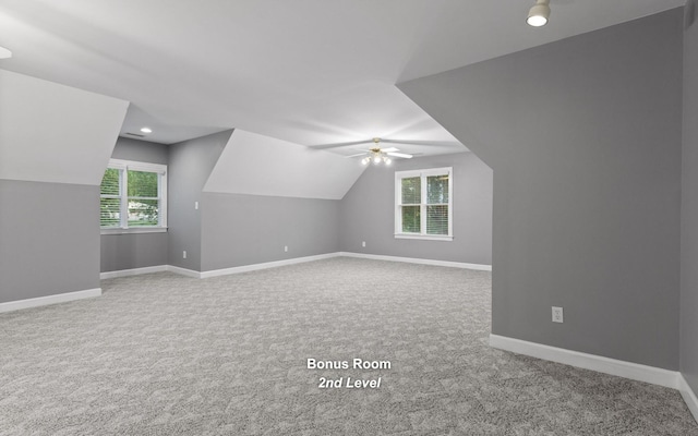 additional living space featuring lofted ceiling, carpet, ceiling fan, and baseboards