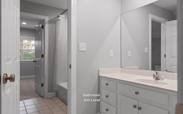 bathroom with vanity, tile patterned flooring, toilet, a shower with shower curtain, and baseboards