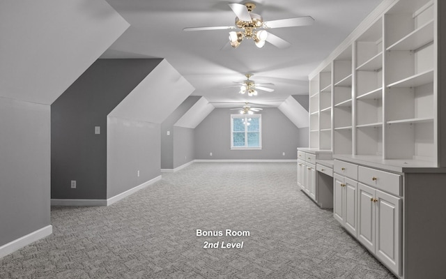 additional living space featuring ceiling fan, light carpet, baseboards, and lofted ceiling