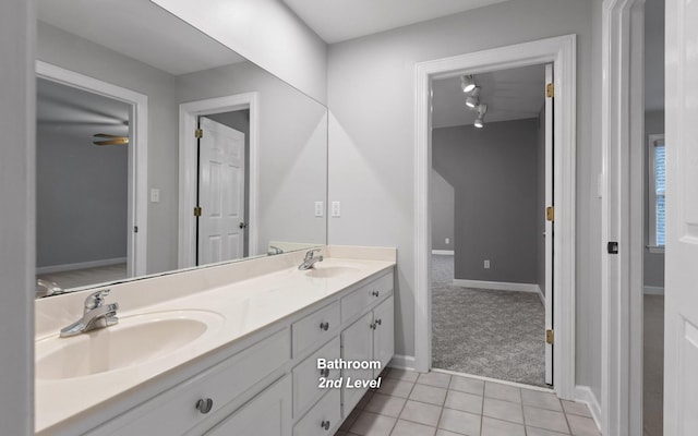 full bathroom featuring tile patterned floors, double vanity, and baseboards