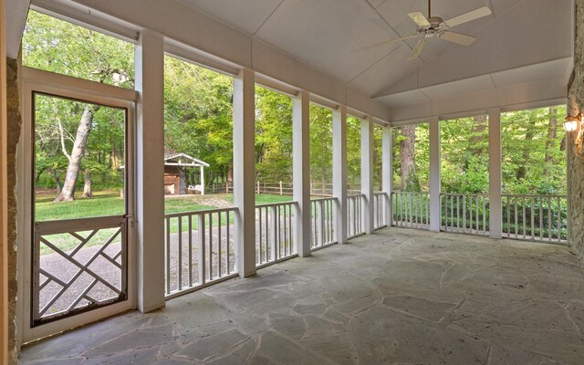 unfurnished sunroom featuring ceiling fan