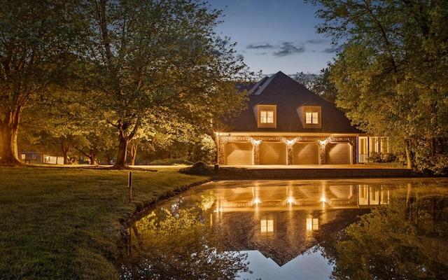 back of property at dusk with driveway