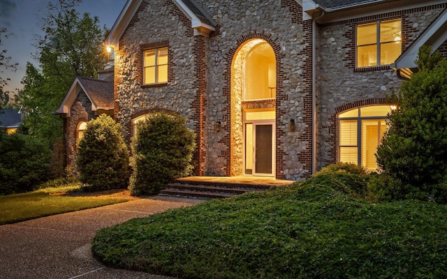 view of front of home featuring stone siding and brick siding