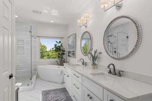 bathroom with a shower stall, a freestanding bath, double vanity, and recessed lighting
