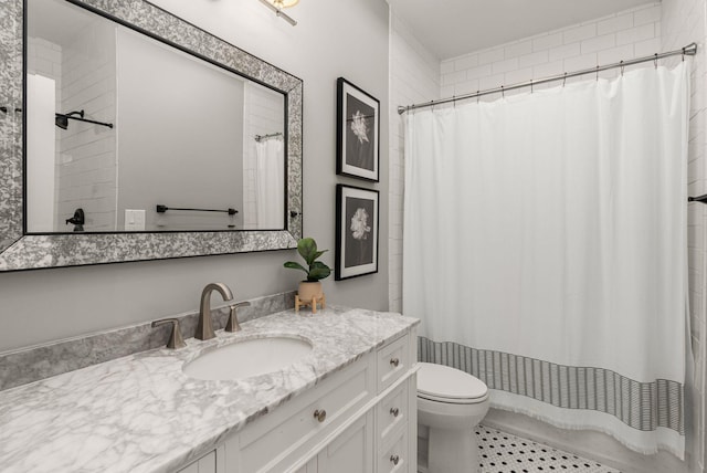 full bathroom featuring toilet, vanity, and tile patterned floors