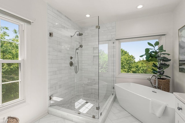 full bath with a stall shower, a soaking tub, and recessed lighting