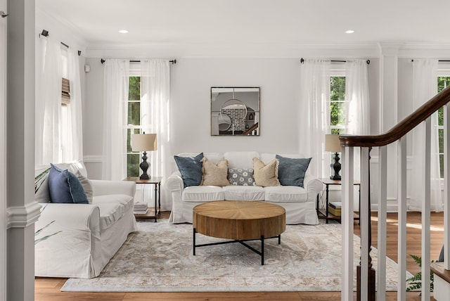 living room with healthy amount of natural light, ornamental molding, wood finished floors, and recessed lighting
