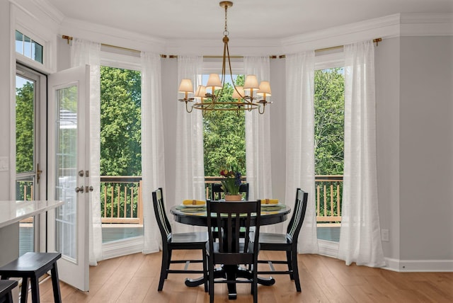 sunroom / solarium with french doors, a chandelier, and plenty of natural light
