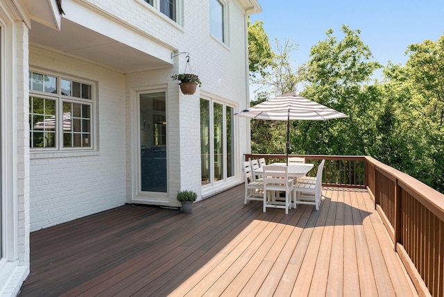 wooden deck featuring outdoor dining space