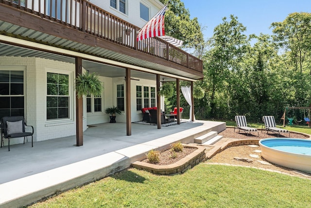 view of patio with a ceiling fan and an outdoor pool