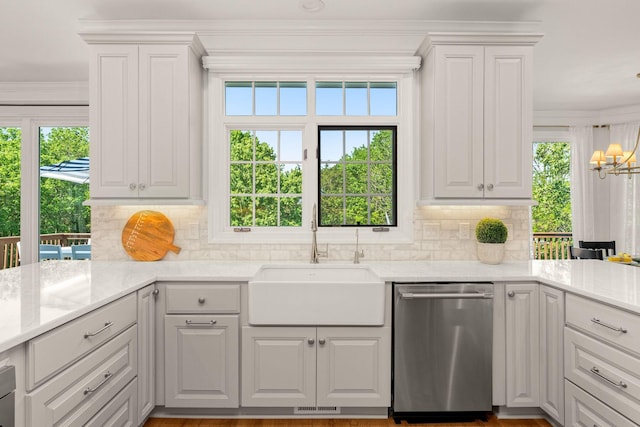kitchen featuring dishwasher, a sink, crown molding, a chandelier, and backsplash
