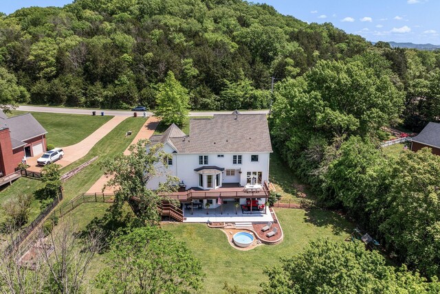 view from above of property with a heavily wooded area