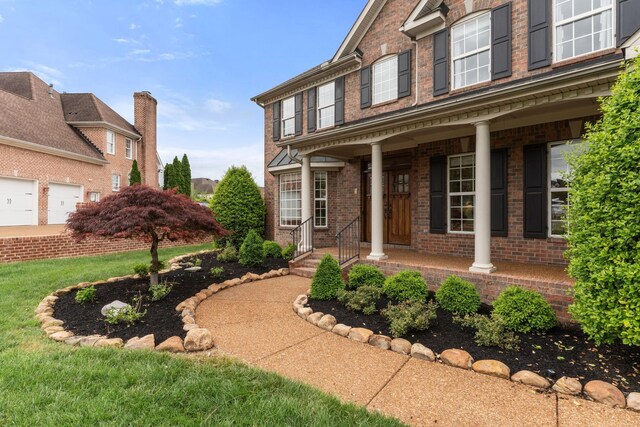 1115 Rossifer Ct, Gallatin, TN 37066 - entrance to property featuring brick siding, a porch, and a lawn