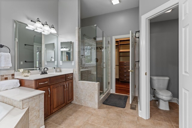 1115 Rossifer Ct, Gallatin, TN 37066 - bathroom featuring a shower stall, tile patterned floors, vanity, toilet, and a walk in closet
