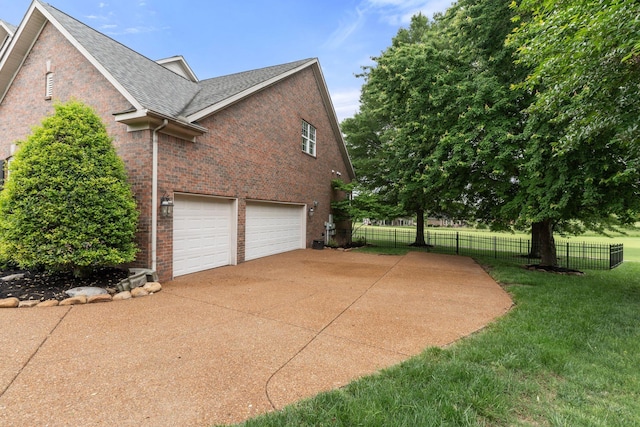 1115 Rossifer Ct, Gallatin, TN 37066 - view of side of home featuring brick siding, a garage, driveway, and roof with shingles
