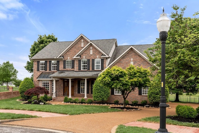 1115 Rossifer Ct, Gallatin, TN 37066 - view of front of house with brick siding, covered porch, and roof with shingles