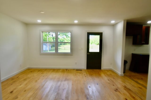 foyer featuring light wood-style floors, baseboards, and recessed lighting