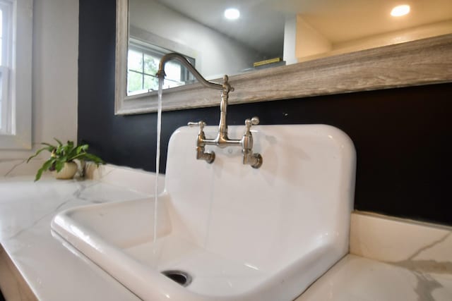 bathroom view of recessed lighting and a sink