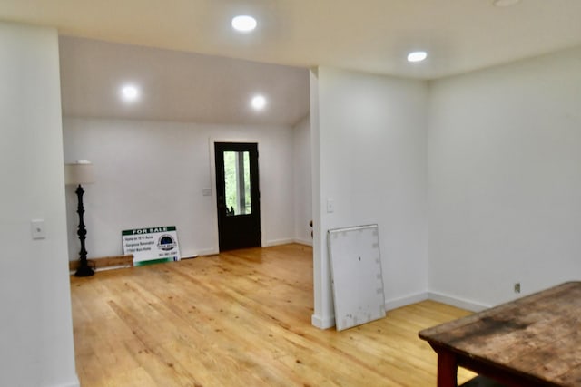 entryway with wood finished floors, recessed lighting, and baseboards