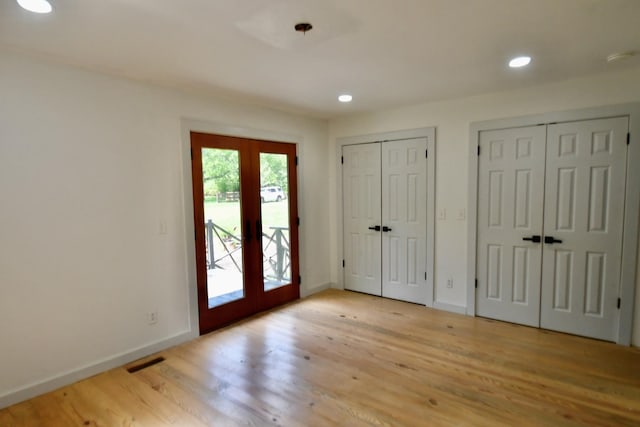 entryway featuring french doors, wood finished floors, baseboards, and recessed lighting