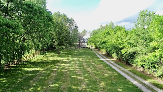 view of yard featuring dirt driveway and a view of countryside