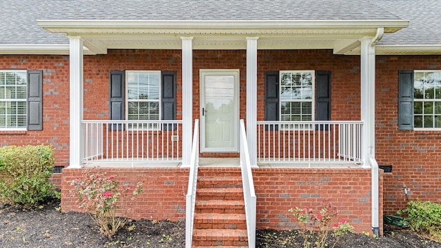 1165 Short Springs Rd, Tullahoma, TN 37388 - view of exterior entry featuring a shingled roof, brick siding, and a porch