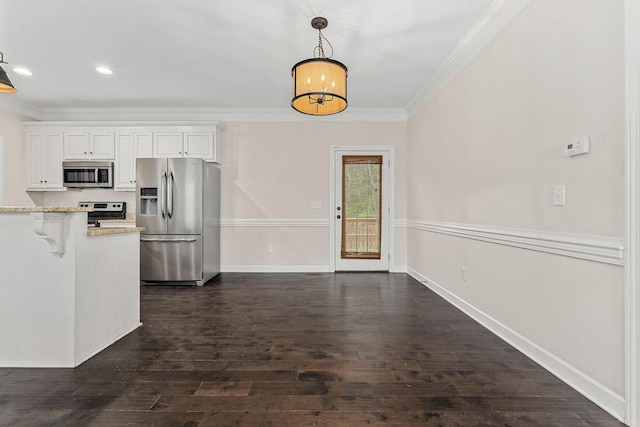 1165 Short Springs Rd, Tullahoma, TN 37388 - kitchen with appliances with stainless steel finishes, ornamental molding, hanging light fixtures, white cabinetry, and dark wood-style flooring