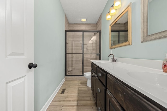 1165 Short Springs Rd, Tullahoma, TN 37388 - bathroom with a shower stall, toilet, double vanity, a textured ceiling, and wood finished floors