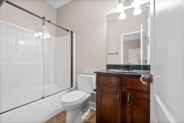 bathroom with toilet, vanity, and combined bath / shower with glass door