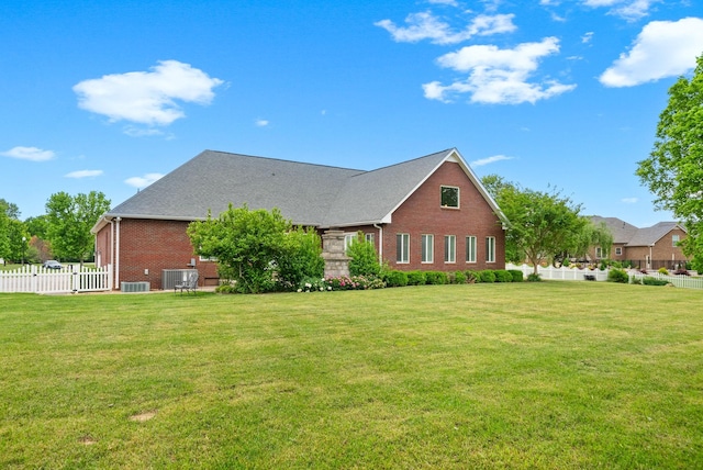 view of side of property featuring brick siding and central air condition unit