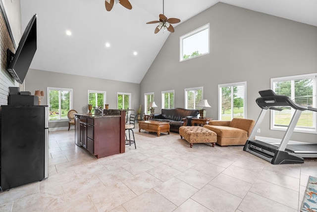 living area with high vaulted ceiling, a ceiling fan, and recessed lighting