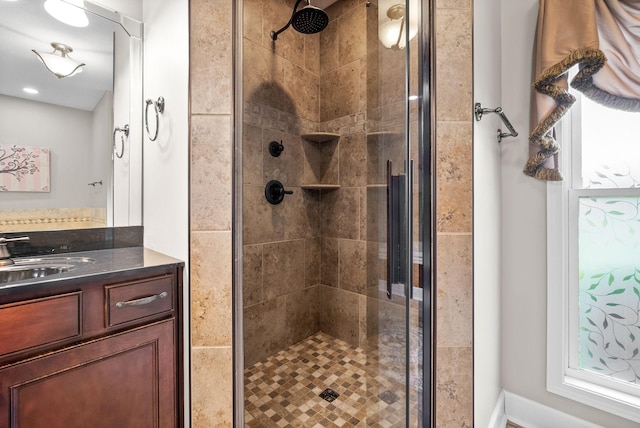 bathroom featuring a shower stall and vanity