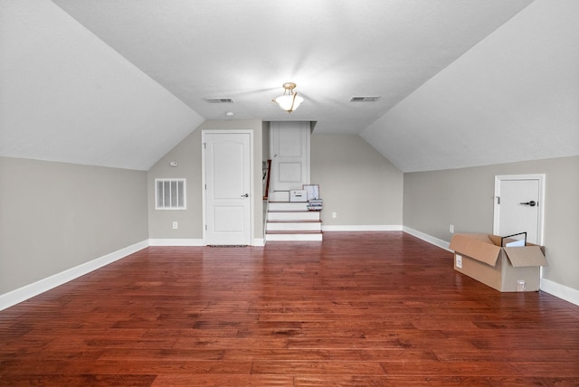 bonus room featuring lofted ceiling, wood finished floors, and baseboards