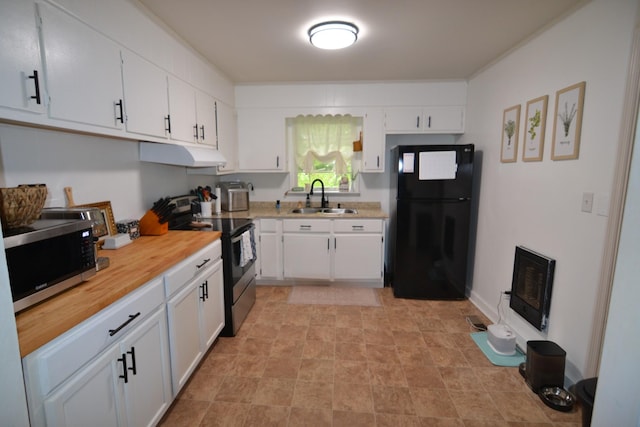 800 E Grigsby St, Pulaski, TN 38478 - kitchen featuring appliances with stainless steel finishes, a sink, under cabinet range hood, and white cabinets