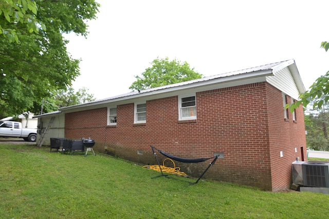 800 E Grigsby St, Pulaski, TN 38478 - view of side of property with a yard, brick siding, metal roof, crawl space, and central air condition unit
