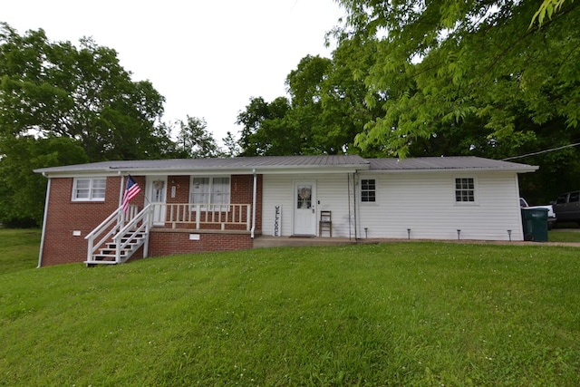 800 E Grigsby St, Pulaski, TN 38478 - view of front of home featuring a front yard, metal roof, and covered porch