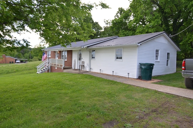 800 E Grigsby St, Pulaski, TN 38478 - ranch-style home featuring a porch, a front yard, and metal roof