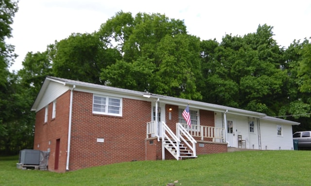 800 E Grigsby St, Pulaski, TN 38478 - single story home featuring covered porch, a front yard, brick siding, and view of scattered trees